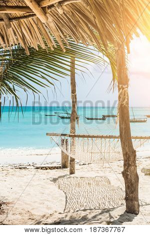 beautiful colorful seascape with hammock and palm on a beach