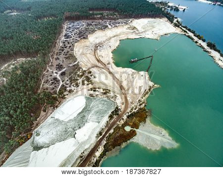 Aerial view - blue water in pond, sandy career