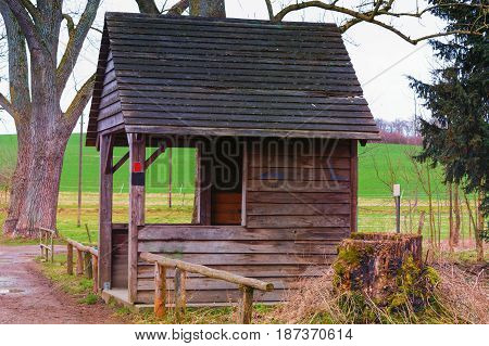 Old wooden hut to shelter from wind rain or snow at a pond near the town of Heiligenhaus in Germany.