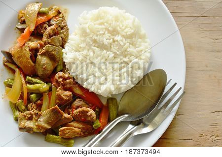 stir fried chicken and mixed entrails with sweet chili eat couple with rice on plate