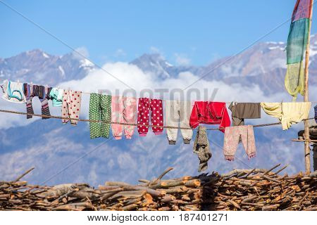 Drying laundry on the roof of nepalese brick house with mountains background