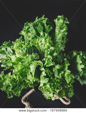 Green lettuce leaves on a background of white brick wall fresh healthy salad food on kitchen table space mock up dieting leaf vegan corn on wooden on space background organic plant crop close up