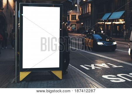 Blank advertising light box on the bus stop, mockup of empty ad billboard on bus station, template banner on background city street for message or text in Barcelona, afisha board