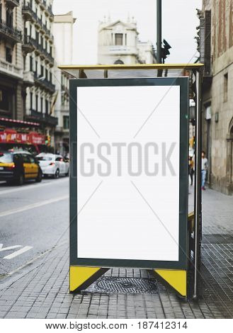 Blank advertising light box on the bus stop mockup of empty ad billboard on bus station template banner on background city street for message or text in Barcelona afisha board