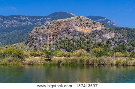 TURKEY, MUGLA ,DALYAN, - 5 MAY , 2017: The Dalyan River with tourist boats in the straits of the river