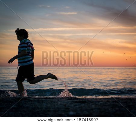 Happy boy enjoying the beach