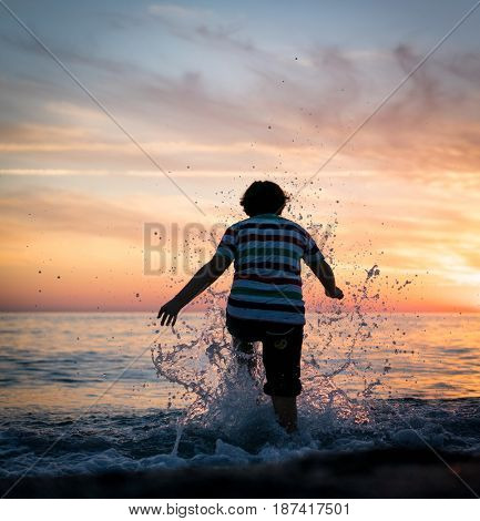 Happy boy enjoying the beach