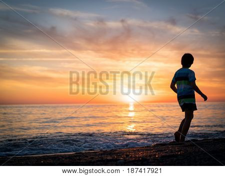 Happy boy enjoying the beach