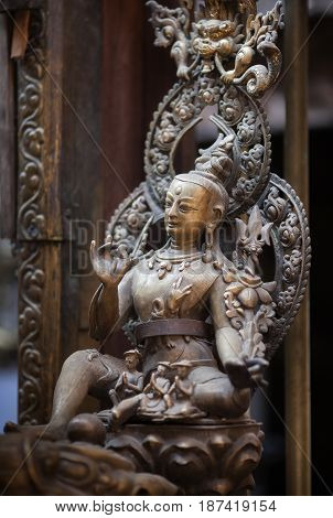 Ancient statue of a bodhisattva of Avalokiteshvara made of bronze in nevara style in the Golden Temple Lalitpur Kathmandu Nepal.