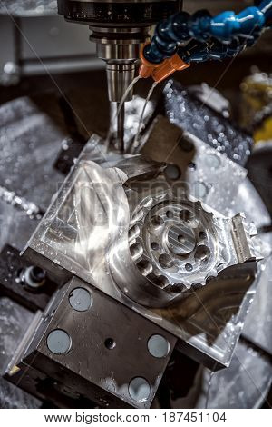Metalworking CNC milling machine. Cutting metal modern processing technology. Small depth of field. Warning - authentic shooting in challenging conditions. A little bit grain and maybe blurred.