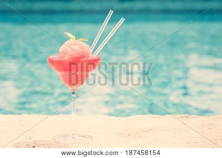 Frozen Strawberry Margarita Cocktail At The Edge Of A Resort Pool.  Concept Of Luxury Vacation
