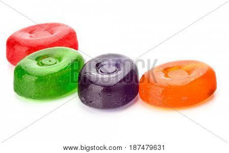 Four colorful fruit hard sugar candies,  boiled sweeties or sugar plums isolated on white background cutout