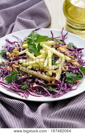 Salad red coleslaw with apple slices and crushed walnut