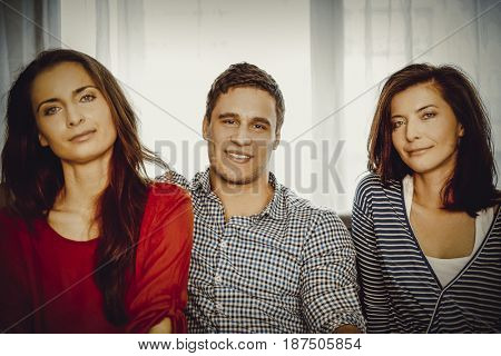 Sisters and brother relaxing at home.