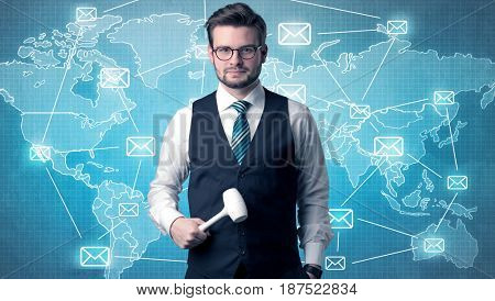 Businessman holding tool with global map graphic on the background