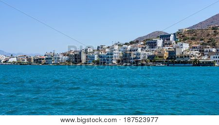 CRETE GREECE - JULY 11 2016: The embankment of a small elite tourist town - Elounda municipality of Agios Nikolaos. View from the sea.