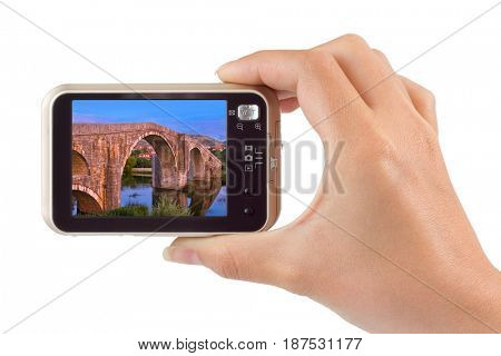 Hand with camera and Old bridge in Trebinje - Bosnia and Herzegovina image (my photo) isolated on white background