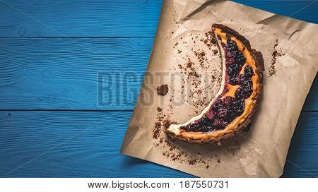 Top View Of Cheesecake On The Kraft Paper On The Blue Boards