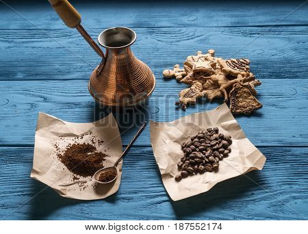Coffee Beans, Ground Coffee, A Turk, A Silver Spoon For Kraft Paper And Christmas Cookies On The Blu