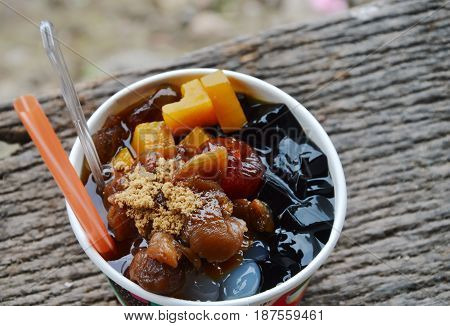 assorted Chinese cold sweetmeat with ice in paper cup
