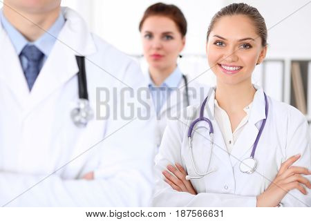 Happy doctor woman with medical staff at the hospital.