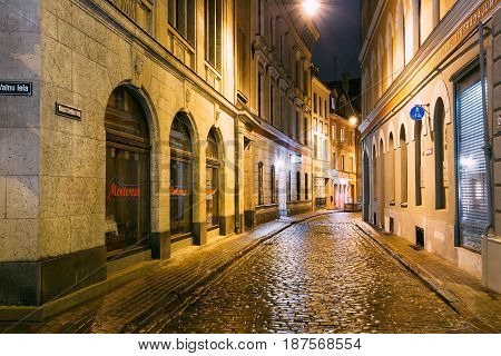 Riga, Latvia - July 3, 2016: Restaurant Cafe In Lighting In Night Illumination In Old Town In Maza Smilsu Street