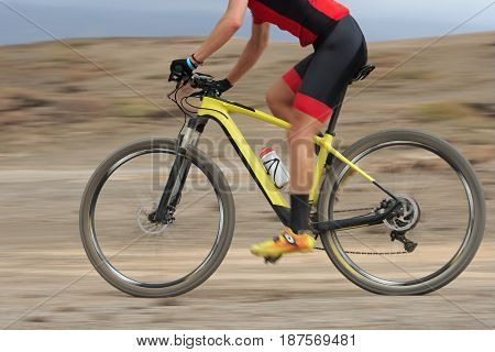 Motion blur of a mountain bike race with the bicycle and rider at high speed