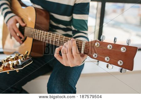 Learning to play the guitar. Music education and extracurricular lessons. Guitarist