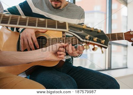 Learning to play the guitar. Music education and extracurricular lessons. Guitarist