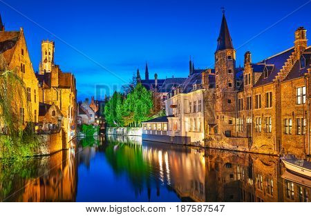Bruges. Channel Rozenhoedkaai view to Perez de Malvenda house and Belfort tower. Belgium blue evening time.