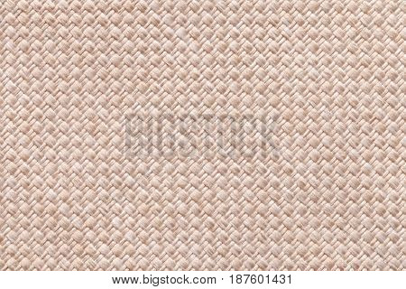 Light pearl woolen background of dense woven bagging fabric closeup. Structure of the cream cloth with natural texture. Cloth backdrop.
