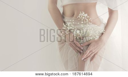 Lovely girl in white lingerie. Sensual photo. Man is unrecognizable