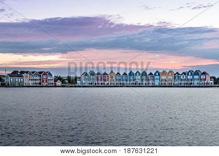 Houten Netherlands - August 4 2016: Calm evening at the famous Rainbow houses in the Netherlands. Colored wooden houses.
