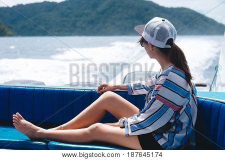Side View. Asia Woman Sitting On Back Of Boat And Looking Scenery Sea View Have Island Are Backgroun