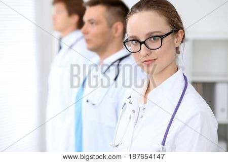 Happy doctor woman with medical staff at the hospital.