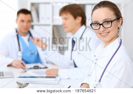 Happy doctor woman with medical staff at the hospital.