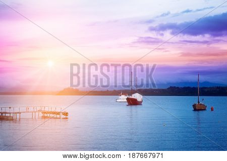 Evening lake with boats and coastline in Puerto Varas