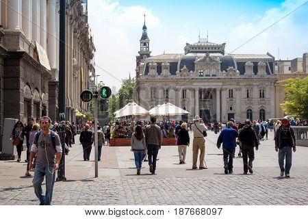 SANTIAGO CHILE - OCTOBER 23 2016: People walking on Plaza de Armas with Central Post Office Building (Correo Central) on the background. This is a historic house and a famous touristic attraction.