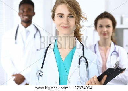 Medical team of confident doctors showing Ok sign and ready to help. Medicine and health care, insurance concept.