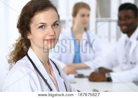 Happy doctor woman with medical staff at the hospital.