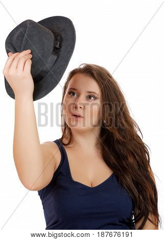 The Girl Looks Surprised At The Hat In Her Hand On A White Background
