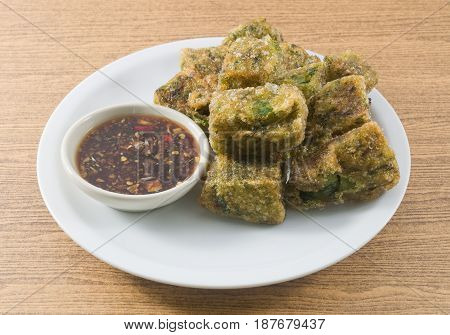 Plate of Fried Chinese Pancake or Fried Steamed Dumpling Made of Garlic Chives Rice Flour and Tapioca Flour Served with Spicy Soy Sauce. Traditional Food of China.