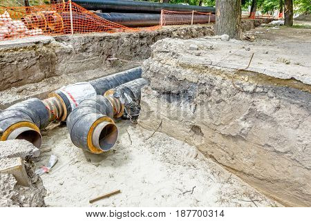 View of unfinished diverting new pipeline in trench.