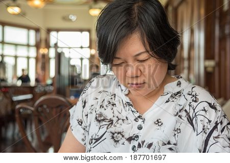 Asian Women Look Menu In Coffee Shop Vintage Style
