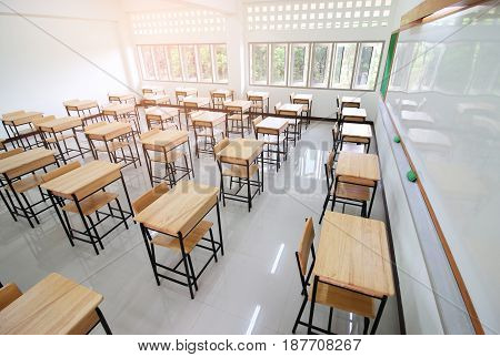 School classroom with desks chair wood and blackboard in high school thailand vintage tone education concept