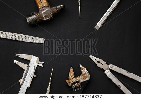 Tools For Repairing And Renovation Concept On Black Background Top View. Hammer Pliers, Screwdriver,