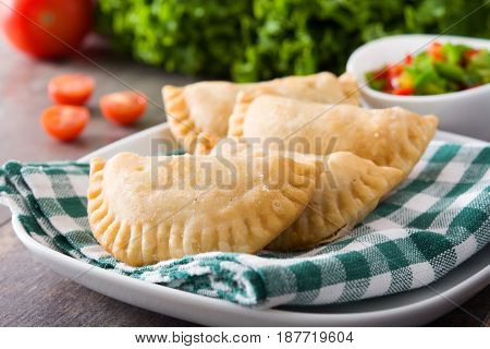 Delicious typical Spanish empanadas on wooden table