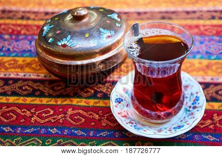 Thr black turkish tea in traditional glass.