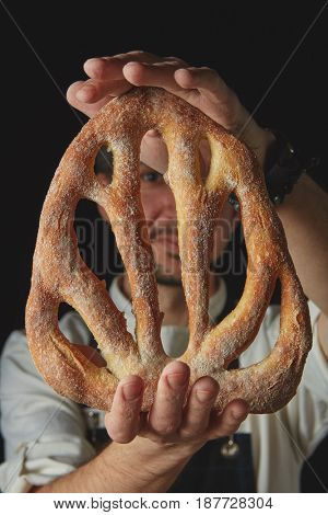 Hands men holding fougas bread