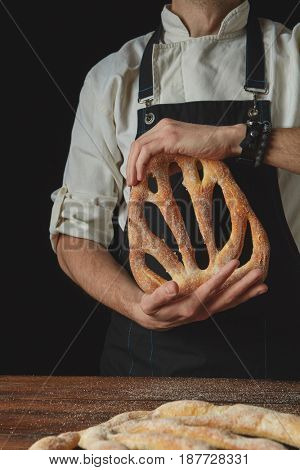 Hands men holding fougas bread